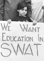 A file photo of a young girl with a placard condemning the attacks on girls' schools in scenic Swat valley during a protest organised by the Pashtoonkhwa Students Organisation, which represents students from Pakistan's troubled northwest, in Karachi. 
