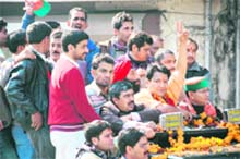 Jaspal Rana, BJP candidate for Tehri Garhwal, is received by party supporters on his arrival in Dehradun on Monday.