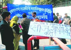 Protesting lecturers with placards against the government in Dehradun on Monday.