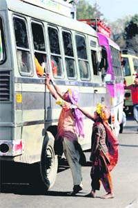 Beggars ask for alms from passengers at the local bus stand in Jammu.