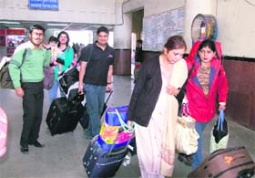 Passengers carry luggage themselves at the Jalandhar city railway station in the absence of porters