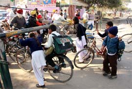 School children crossing a manned railway crossing in Bathinda on Tuesday.