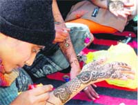 A girl participates in a Mehendi competition in Haridwar on Tuesday.