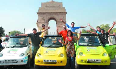 Members of the Indian Youth Climate Network pose with their electric cars at the India Gate in New Delhi on Wednesday after their five-week journey