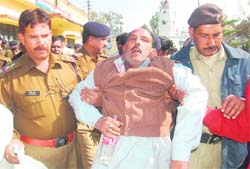 An injured Congress worker being taken to hospital by the police following a fight with BJP workers in Dehradun on Wednesday. 