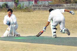 Wicket-keeper takes off the bails as the batsman makes an attempt to complete a run at the ongoing 57th District Cricket League at Survey Stadium in Dehradun on Wednesday. 