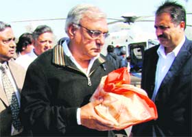 Chief Minister Bhupinder Singh Hooda carries the ashes of his father, Ranbir Singh Hooda, for immersion in the Bhakra Dam