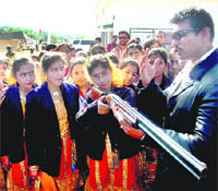 Olympic silver medal winner Rajyavardhan Rathore gives tips to schoolgirls at the inaugural function of the All-India Sajjan Singh Sethi Memorial Masters Shooting Championship in Akhnoor on Wednesday.