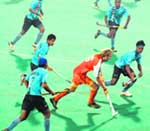 A Holland player in tussle with Indian players for ball possession in Chandigarh