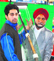 Gurdev Singh (right) exhibits the historic hockey stick at the Sector 42 Hockey Stadium in Chandigarh on Friday.