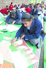 Students give colour to their creations during an on-the-spot competition in Jammu on Friday.