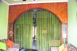 This wood arch leads to the Joshi living room