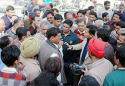 K.K. Yadav, commissioner, Bathinda Municipal Corporation, talking to shopkeepers on Mall road during a demolition drive in Bathinda