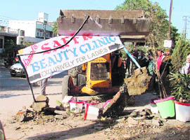 A display board which was brought down by a team of the Municipal Corporation in Ludhiana on Saturday.
