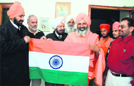 Balbir Singh Seechewal being presented Tricolour by the residents of Shaheed Bhagat Singh Nagar in Ludhiana on Saturday.