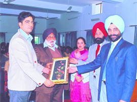 Prof Gagandeep Sharma being honoured by principal and faculty members of the commerce department of GNN College in Doraha.