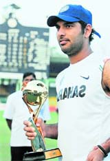 Yuvraj holds the Man of The Series trophy