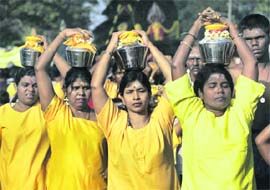 Hindu devotees take part in a procession during the Thaipusam festival at Batu Caves in Kuala Lumpur, Malaysia, on Sunday.