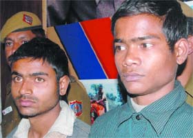 Two persons being produced in front of media by the Delhi police south district after it arrested four persons involved in 15 burglaries in posh areas and recovered gold and electronic items worth Rs 10 lakh in New Delhi