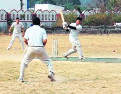 A batsman strikes the ball at the 57th District Cricket League at Survey Stadium, Dehradun on Monday. 