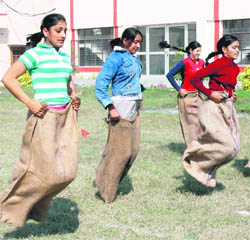 Students of KVA DAV College for Women take part in a sack race at the annual athletic meet of the institution in Karnal.