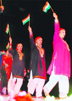 Girls hold aloft Tricolour at the inauguration of Doordarshans five-day music festival in Jammu on Monday.