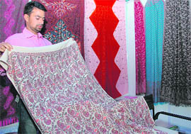 Shafiq Ahmed Shah, a Kashimiri shawl-maker, displays the 156-year-old shawl prepared by his ancestors at the Trade Fair in Dehradun on Tuesday.
