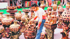 A girl looks at terracotta items displayed at the international trade fair in Dehradun.