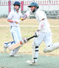 Batsmen steal a run at the 57th District Cricket League at Survey Stadium, Dehradun.