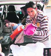 Aman (1), who was thrown out of a running train along with members of his family by some miscreants near Hodal railway station, is taken to hospital in Faridabad on Tuesday. 
