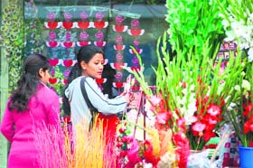 Girls buy flowers on Rose Day in Gandhi Nagar in Jammu