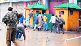 Youths pelt a CRPF camp with stones during a protest at Lal Chowk in Srinagar