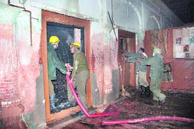 Firefighters try to douse flames inside the Mubarak Mandi Complex in Jammu