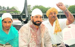 Col Ajit Singh (right) shows injury marks on his arm as his nephew Jarnail Singh with bandaged head and blood-stained clothes sits behind him at the War Memorial in Chandigarh on Tuesday.