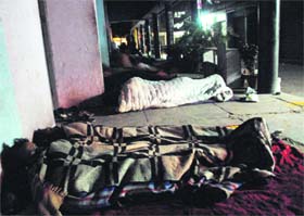 People sleep in the corridor of Sector 23 Market