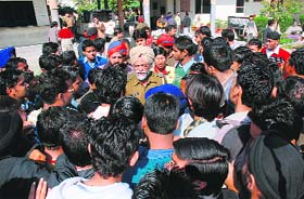 A cop tries to pacify students at Kamla Lotiya College in Ludhiana