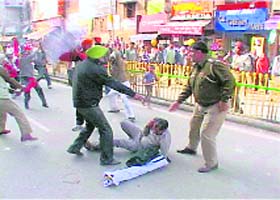 A protester being over powered by the police near Jallianwala bagh in Amritsar