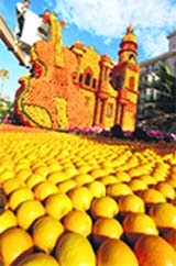 Workers give final touches to a violin made from lemons and oranges during the lemon festival in Menton in southern France on Thursday.