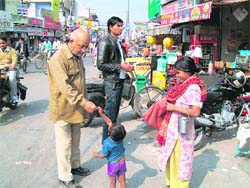 A child begs on a street in Roorkee.