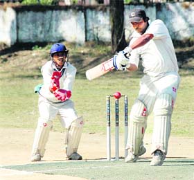 A batsman plays a shot during a semifinal at the Dehradun District Cricket League in Dehradun