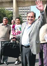 Haryana Finance Minister Birender Singh waves while he carries his Budget papers to the Assembly in Chandigarh on Friday.