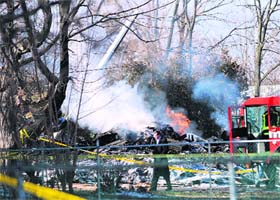 An investigator walks through the scene of a Continental Airlines crash on Friday in Clarence Center, New York, just north and east of Buffalo