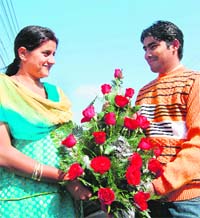 A couple exchanges roses on Valentines Day in Amritsar on Saturday.