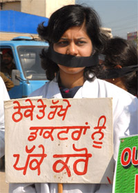 A rural doctor with black tape on her mouth stages a symbolic protest at Kamla Nehru Colony in Bathinda on Sunday during the visit of Harsimrat Kaur Badal.