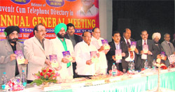 Office-bearers of the AIOCD, the PCA and the LDCA pose with souvenir-cum-telephone directory at the annual general body meeting in Ludhiana on Sunday.