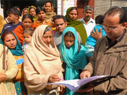 Wife of the deceased Kulwant Rai (above), signing the performa for voluntary donation of the body in Bathinda on Monday. 