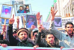 Activists of the Peoples Freedom League hold protest against human rights violation in Srinagar on Monday. 