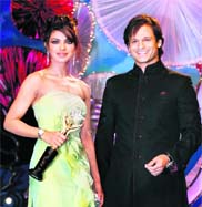 Actor Priyanka Chopra poses with actor Vivek Oberoi after receiving the 'Star of the Year' award from him