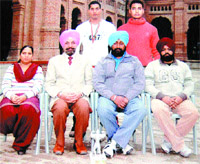 Sportsmen Ravinder Singh and Harpreet Singh (standing) with their Khalsa College Principal Dr Daljit Singh (second from left) and other staff members of physical education department in Amritsar.