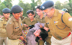 Nursery Trained Teachers Association president Yogita Joshi being taken away by the police in Dehradun